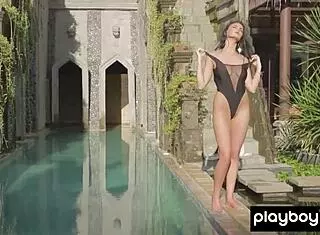 Big boobed brunette Ashleigh Hannah slowly undresses by the pool, unveiling her desirable pussy in a solo outdoor scene