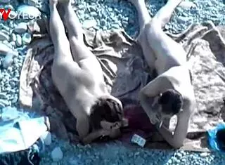 yo, check this hot babe givin’ head on a public beach