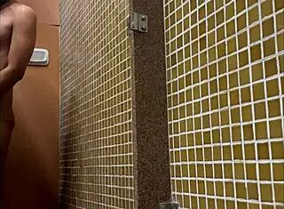 this muscular twink is showering in the gym, and i'm spying on his big cock