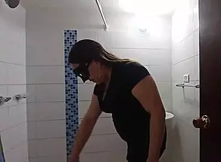 A wife seduces her brother-in-law in the bathroom while cleaning, showing her cameltoe.