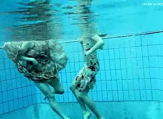 anna and lada relax in pool with bikinis on brunette beauties