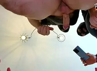 Wife performs double blowjob with cum-filled mouth in threesome scene.