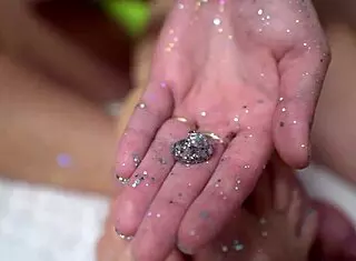 two cuties with shiny legs are playing with a huge rubber cock, giving it a footjob