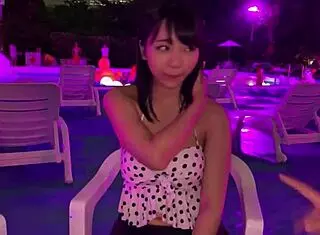 Asian babe in night pool with big tits and lotion