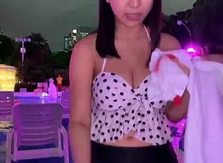 Asian babe in night pool with big tits and lotion