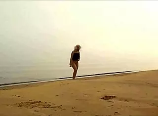 voyeur watches couple dancing on desert island with friends